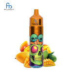 A colorful vape device with a skull graphic and two smaller skulls on top, surrounded by various fruits, including mangoes and slices of pineapple.