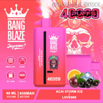 Colorful disposable vape device labeled 'Bang Blaze Joycome' with '4000 puffs,' flavor 'Acai Storm Ice,' and illustrated fruits and ice cubes in front of a stylized skull with a feathered headdress on a bright pink background.