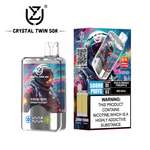 Crystal Twin 50K disposable vape with 50,000 puffs, double flavor of peach mango pineapple and red bull, astronaut artwork on the device and packaging, and a nicotine addiction warning label.