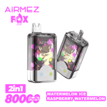 Two transparent AiRMEZ Fox vape devices with metallic bases, each featuring a cartoon fox wearing a hat on their front screens; the image includes text highlighting '2in1', '8000 puffs', and the flavors 'Watermelon Ice' and 'Raspberry Watermelon' in bright pink lettering.