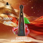 A tall dark tequila bottle labeled 1942 Tequila stands upright with a cherry, dragon fruit motif and golden ribbon background; text reads 30000 Puffs and CHERRY DRAGON FRUIT.