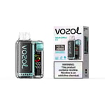 Vozol Vista 20000 pod-style vape device with carbon fiber pattern, mint accents, and a display panel next to a matching box labeled “SOUR APPLE ICE” and warning text.
