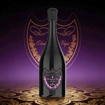 A sleek black bottle of sparkling Champagne standing upright with a pink ornamental label, set against a purple background with a golden crest and decorative pattern.