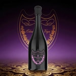 A tall dark champagne bottle with a glossy black finish and a pink bordered label, set against a purple gradient background with gold ornate designs.