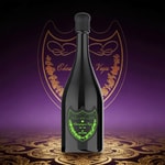 A tall, dark champagne bottle with a frosted black top and a green, ornate crest label.