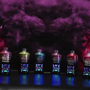 Row of colorful bottles with glowing labels lined up on a dark surface, neon pink lights and smoky background creating a vibrant, club-like scene.