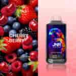 Un assortiment de cerises, fraises, framboises et myrtilles avec une bouteille étiquetée " JNR Cherry Berry " comportant une illustration colorée de faucon.
