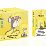 A yellow vaping device and its packaging, featuring a cartoon monkey wearing sunglasses and a yellow outfit. The device is labeled "Peach Mango Pineapple" and includes warnings about nicotine.