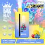 Colorful advertisement for a Bang Blaze disposable vape with a gradient yellow and blue device, fruit illustrations of lemon, cherry, and blueberries, a surreal artwork of a headless suit, and a vibrant skull background, highlighting 4000 puffs and flavor options of pink lemonade and blueberry cherry lemon.