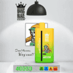 Bang Blaze Color vape device with green and yellow gradient, featuring a skeleton in a hoodie design, product branding, and icons indicating dual flavors, 4000 puffs, Type-C charging, and 40ml e-liquid capacity displayed under a lamp on a marble surface.