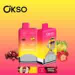 Colorful OKSO double flavor vape devices with cherry and strawberry banana flavors, featuring cartoon monkey design and surrounded by images of cherries, strawberries, and bananas against a yellow to pink gradient background.