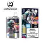 Crystal Twin 50K vape device and packaging featuring a colorful astronaut graphic, advertising 50,000 puffs, two flavors (Blueberry on Ice and Summer Peach Ice), double flavor capability, and a nicotine addiction warning label.