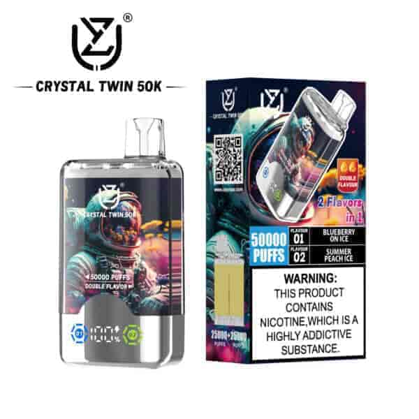 Crystal Twin 50K vape device and packaging featuring a colorful astronaut graphic, advertising 50,000 puffs, two flavors (Blueberry on Ice and Summer Peach Ice), double flavor capability, and a nicotine addiction warning label.