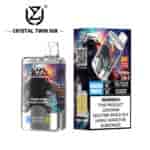 Crystal Twin 50K disposable vape device and packaging featuring a colorful astronaut design, 50,000 puff capacity, double flavor (kiwi passion fruit guava and blueberry raspberry), and a nicotine addiction warning label.