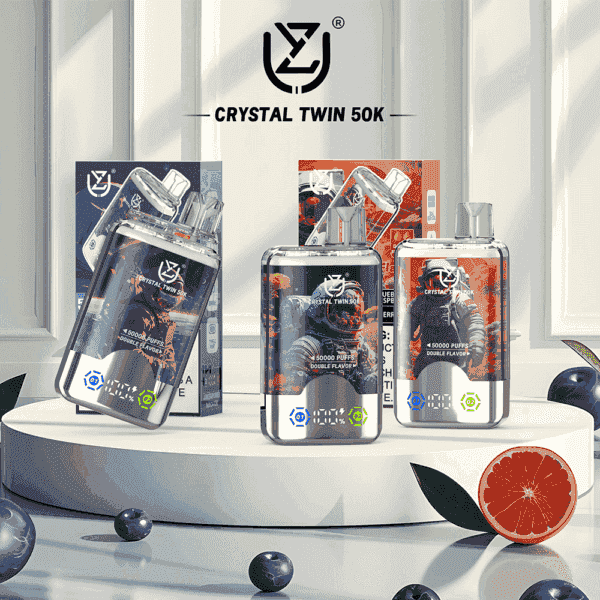 Three Crystal Twin 50K vape devices with futuristic astronaut-themed packaging displayed on a white platform, surrounded by blueberries and a halved grapefruit for flavor indication.