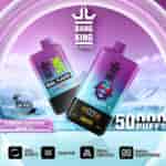 Promotional image for Bang King DelphTech vape featuring two purple-blue gradient devices labeled 'Dual Flavor' and 'Blueberry Raspberry Grape Ice,' with graphics highlighting 50,000 puffs, adjustable airflow, mesh coil, dual flavor capability, and a digital screen display, set against a snowy mountain background.
