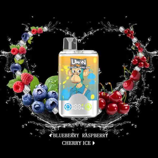 A UWIN Crystal Twins 40K vape device featuring a cartoon monkey on the packaging, surrounded by splashes of water, blueberries, raspberries, cherries, ice cubes, and the flavors blueberry, raspberry, and cherry ice listed below.