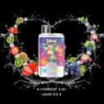 Colorful vape device featuring a cartoon monkey in a vibrant shirt, surrounded by splashes, strawberries, kiwis, grapes, lychees, and ice cubes, with text indicating flavors: Strawberry Kiwi and Grape Ice.