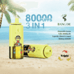 Two yellow Bang De disposable vape devices featuring a cartoon monkey, set on a tropical beach with palm trees and ocean in the background, promoting 80,000 puffs and triple flavor capability.