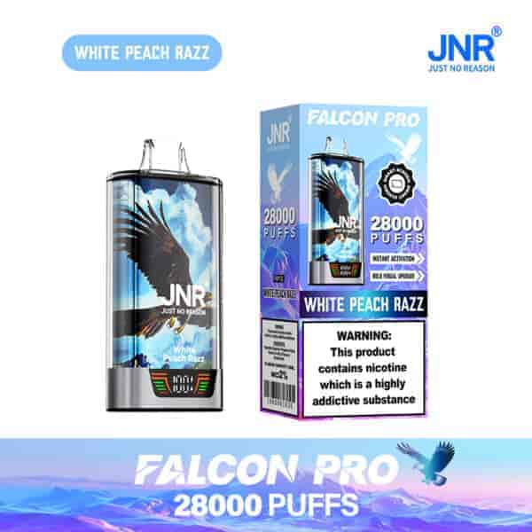 Appareil de vape jetable JNR Falcon Pro et emballage avec une illustration de faucon volant, étiqueté ' saveur White Peach Razz ' et ' 28 000 bouffées ', y compris un avertissement de dépendance à la nicotine.