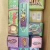 A cardboard box filled with colorful small boxes featuring cartoon characters and bold typography, arranged in neat rows.