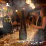 A tall dark bottle of Don Leon 1942 Tequila on a bar counter with a smoky club scene in the background and blurred patrons, golden text reading 30000 PUFFS and enjoy tequila, enjoy vape.