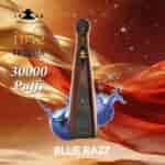 A tall brown tequila bottle labeled Don Leon 1942 with a gold cap, set against a warm, flowing gold and red background, splashing blue liquid and the text “30000 Puffs” and “BLUE RAZZ.”