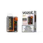 Appareil Vozol Vista 20000 avec un corps en carbone noir et des accents orange à côté de son emballage étiqueté saveur Cherry Cola, mettant en garde contre la nicotine.