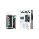 Appareil de vape de type pod Vozol Vista 20000 avec motif en fibre de carbone, accents de menthe et panneau d'affichage à côté d'une boîte assortie étiquetée “ SOUR APPLE ICE ” et un texte d'avertissement.