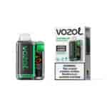 Appareil de vapotage Vozol watermelon bubble gum avec accents verts à côté de son emballage étiqueté Vista 20000 et un avertissement sur la nicotine sur la boîte.