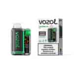 Appareil Vapoteuse Vozoom Vista 20000 avec design en fibre de carbone vert et noir à côté de son emballage blanc étiqueté Vozol Watermelon Ice et une grande étiquette d'avertissement sur la nicotine.