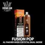 Fusion Pop Al Fakher 8000 Crystal Dual Mode engångsvape med brun flaska och matchande låda med crown-logga och svart/orange gradientförpackning.