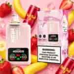 Twins 4000 strawberry banana Red Bull ice vape device and pink box with warning label, surrounded by strawberries, bananas, ice cubes, and a Red Bull can.