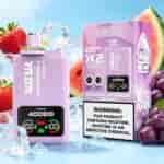 Strawberry watermelon grape ice flavored vape device and purple packaging with digital display, set among fruit and ice cubes.