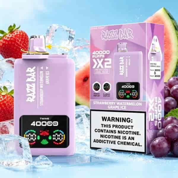Strawberry watermelon grape ice flavored vape device and purple packaging with digital display, set among fruit and ice cubes.