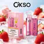 OKSO strawberry ice vape kit with pink patterned bottle and packaging, surrounded by strawberries and ice cubes.