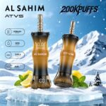 Two vape devices labeled "AL SAHIM" and "ATVS" on an icy surface, with a snowy mountain backdrop, and lemon and mint decorations