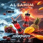 A vibrant advertisement featuring two red and black vape devices against a backdrop of an erupting volcano, with fruits like grapes, pineapple, and mango in the foreground