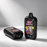 A black vape device with colorful designs featuring an elephant and vibrant splashes sits on a light gray surface, with a digital display showing 81%