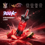 A vibrant red vape device labeled "300K Strawberry Lush" surrounded by fresh strawberries and watermelon, with a cosmic background